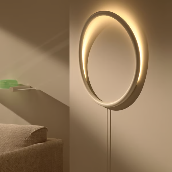 Modern wall-mounted circular lamp with warm, ambient light.
